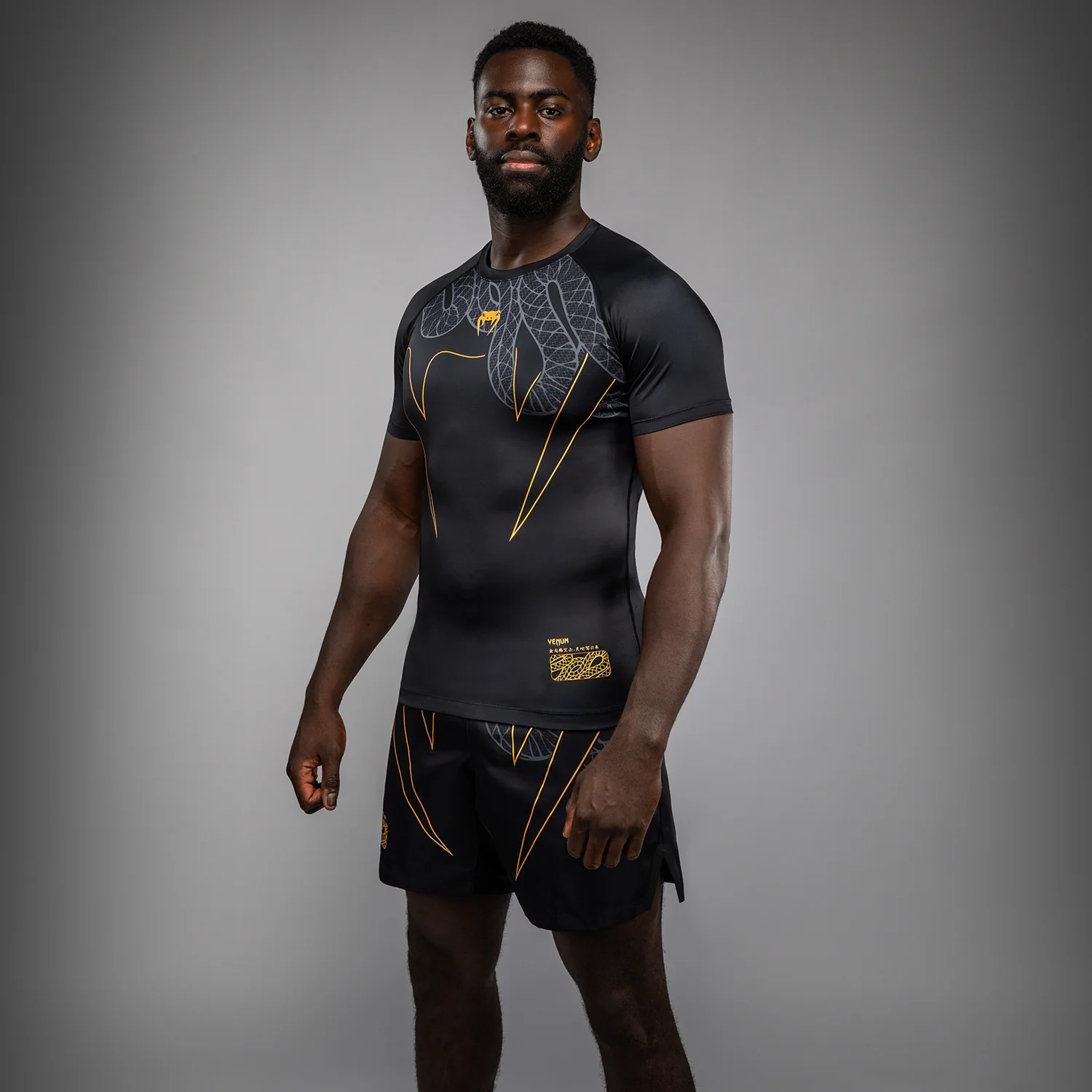 Venum Serpenti Short Sleeve Rashguard - Black/Silver/Gold - Image 2